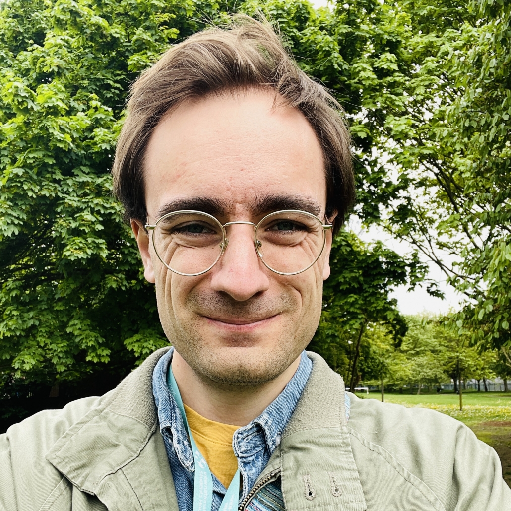 Erlend Birkeland smiling at the camera while in a park